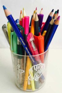 Cup containing various coloring media eg pens, markers, gel pens, and watercolor pencils.